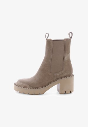 Beige suede ankle boots with elastic side panels, a chunky, textured block heel, and a rounded toe. Features pull tabs for easy wear.