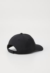 Black adjustable cap featuring a curved peak, textured fabric, ventilation holes, and a strap closure at the back for a secure fit.