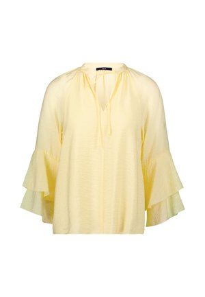 Light yellow blouse with a V-neck, tie detail, and flared sleeves. Made from textured fabric, featuring a relaxed fit and soft drape.