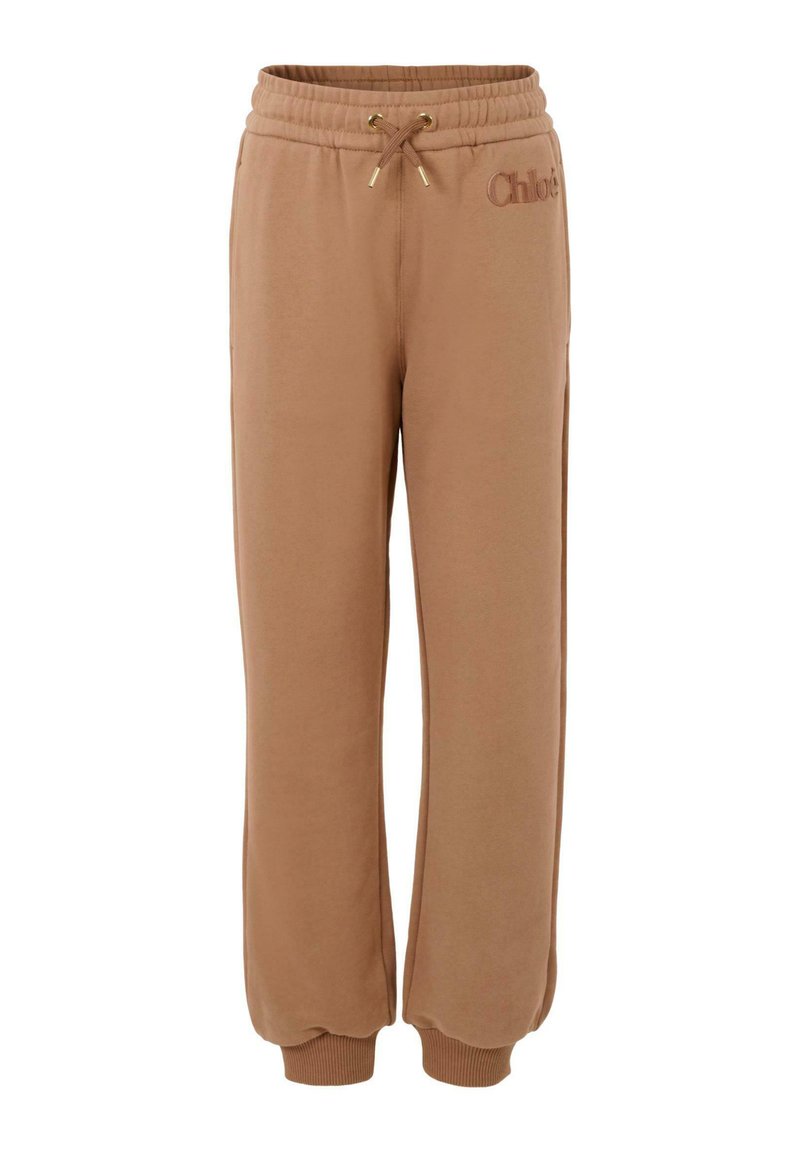 Brązowe dresowe spodnie bawełniane z elastycznym paskiem, regulowanym sznurkiem i wytłoczonym logo. Posiadają ściągacze u kostek dla luźniejszego kroju.