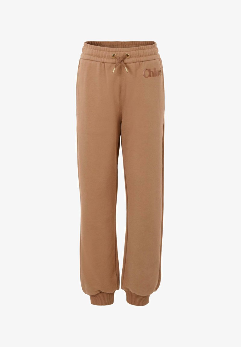 Brązowe dresowe spodnie bawełniane z elastycznym paskiem, regulowanym sznurkiem i wytłoczonym logo. Posiadają ściągacze u kostek dla luźniejszego kroju.