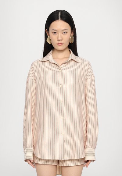 Striped button-up shirt in light beige with thin maroon stripes. Features a relaxed fit, long sleeves, and contrasting striped cuffs.