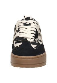 Black and white cow-print sneaker with creamy laces, soft suede accents, and a brown rubber sole, featuring a chunky design.