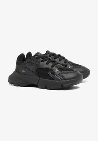 Black athletic shoes with mesh and synthetic material. Rounded shape, textured accents, and sturdy rubber sole with tread pattern.