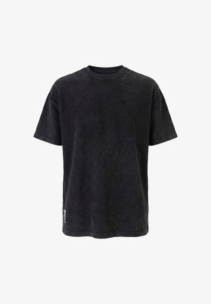 T-shirt noir en velours côtelé à manches courtes avec texture côtelée, encolure ronde, petit logo sur la poitrine et étiquette près de l'ourlet inférieur sur fond blanc.