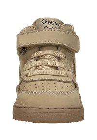 Beige suède sneakers met een klittenbandsluiting, vetersluiting aan de voorkant, geperforeerde teenbox en rubberen zool met sterrenpatronen, ontworpen voor comfort.