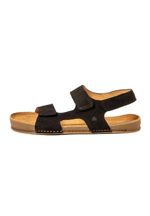 Sandalia abierta de ante negro con dos correas ajustables, suela acolchada color beige, tacón plano y correa trasera para soporte del tobillo.
