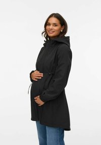 Must emakajope lukustatava tõmblukuga, reguleeritava nöörvöökohaga, kapuutsi ja elastsete mansettidega. Sile kangas ja põlveni ulatuv disain.