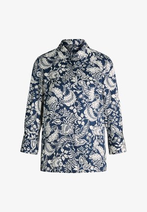 Chemise bleu marine à manches longues avec motifs floraux et feuillages blancs complexes, devant à boutons et col classique.