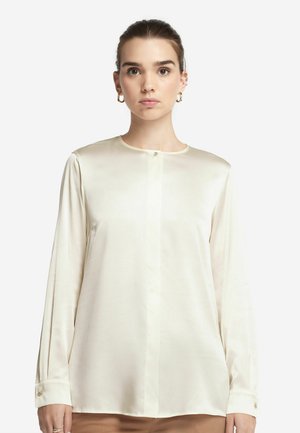Crèmekleurige zijden blouse met lange mouwen, ronde hals, knoopsluiting aan de voorkant en manchettenaccenten. Glad textuur met minimale ontwerpelementen.