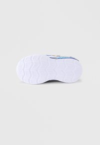 White athletic shoe sole with a textured hexagonal pattern and blue accents. Features branding in yellow and blue on the side.