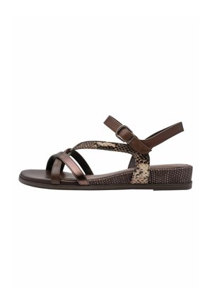 Brown sandals feature cross straps in matte and metallic finishes, with a leopard print accent and a textured wedge sole for added grip.