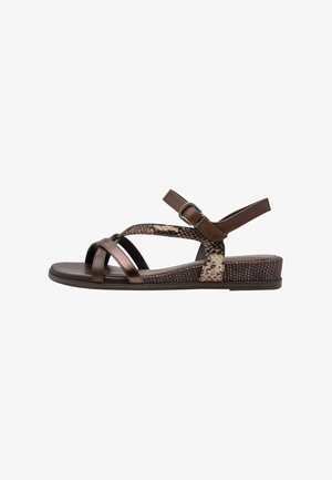 Brown sandals feature cross straps in matte and metallic finishes, with a leopard print accent and a textured wedge sole for added grip.
