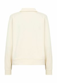 Pulover crem cu mâneci lungi, guler plat, manșete striate și tiv drept. Confecționat dintr-un material moale, cu textură netedă și fără modele vizibile.