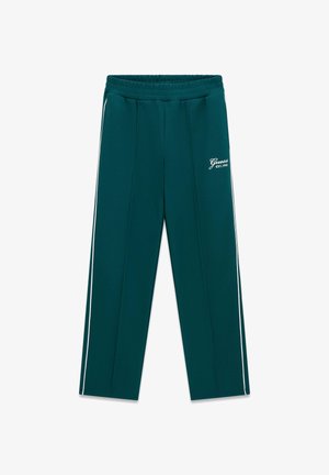 Donkergroene trainingsbroek met witte zijstrepen, elastische tailleband en "Guess EST. 1981" logo op het bovenste linkerbeen.