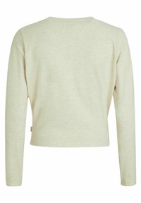 Haut beige clair à manches longues avec un col rond et une coupe droite. Texture douce avec un léger motif chiné. Étiquette sur la couture latérale gauche.