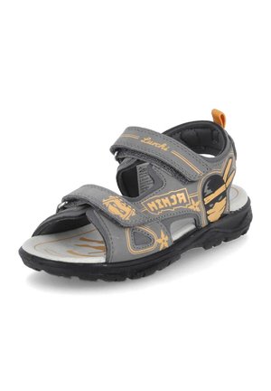 Sandale grise et noire pour enfants avec motifs ninjas jaunes, deux sangles réglables et une semelle noire texturée.