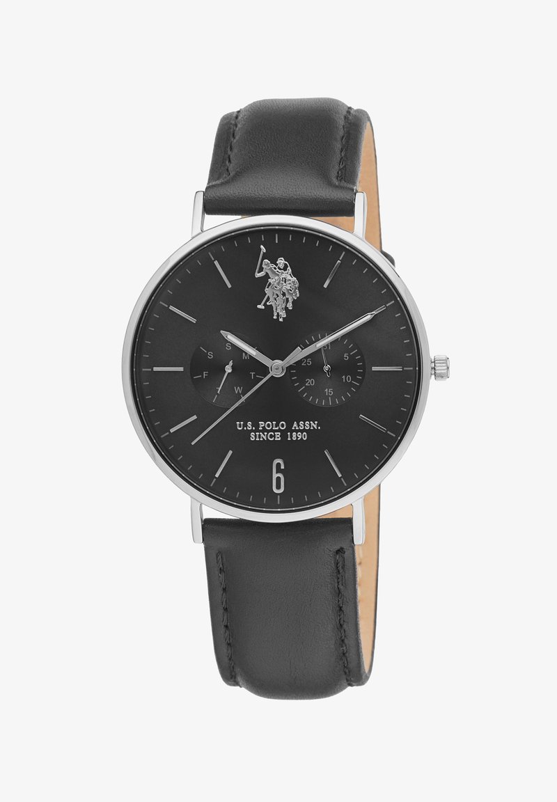 Orologio con cinturino in pelle nera, quadrante tondo nero, dettagli in argento, ore segnate e logo di un giocatore di polo. Sottodial per data e ora.