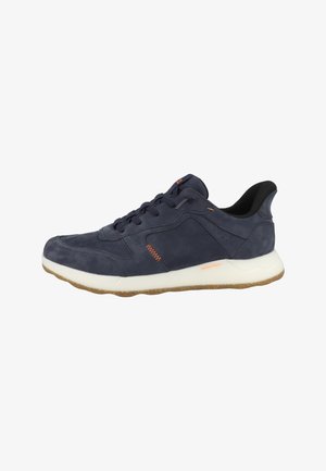 Navy blue casual sneaker with orange stitching accents, white thick sole, and brown textured outsole, side view.