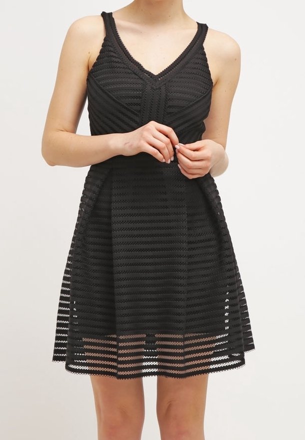 Robe noire avec un corsage ajusté et une jupe évasée. Fabriquée en tissu texturé avec des rayures horizontales. Bretelles spaghetti réglables.