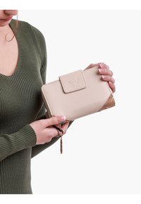 Beige wallet with cork accents, rectangular shape, smooth texture, and front flap closure featuring an embossed logo. Handheld, slim design.