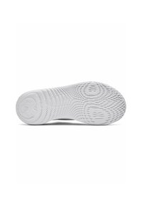 White sneaker outsole featuring a textured pattern for grip, rounded heel, subtle logo, and smooth, durable rubber material.
