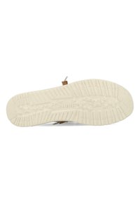 Suola in gomma beige con motivo a trama testurizzata e impronta del logo. Presenta accenti marroni e un design minimalista.