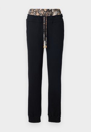 Pantaloni da tuta neri con una vita elasticizzata caratterizzati da un design a motivo di serpente. Include una coulisse e polsini elasticizzati.