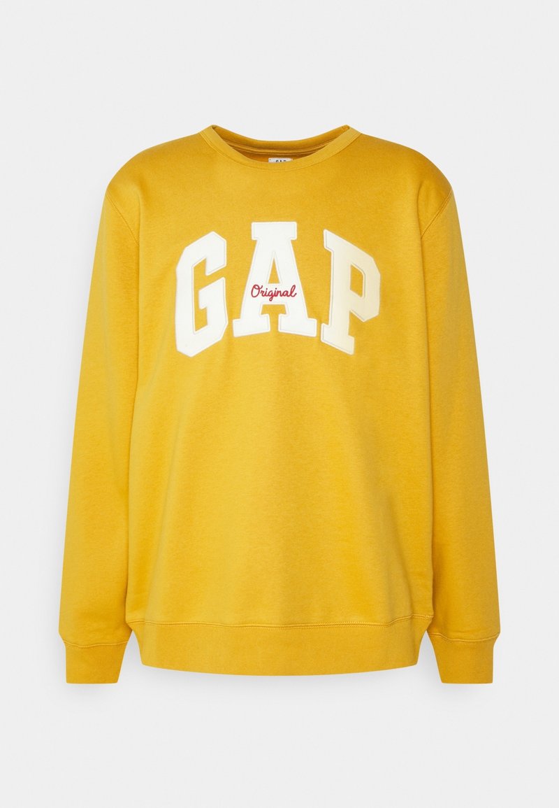 Sweat-shirt jaune avec col rond, manches longues et poignets côtelés. Présente un grand logo "GAP" blanc avec "Original" en rouge en dessous. Le matériau a une texture lisse.
