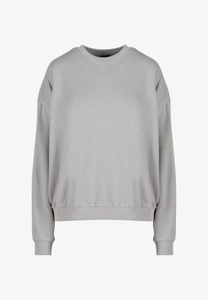 Gaiši pelēks sporta krekls ar apaļu dekoltē, peļķētām plecu vīlēm, ribotām aprocēm un apakšmalu. Audums izskatās mīksts un gluds ar minimālu šuvju skaitu.