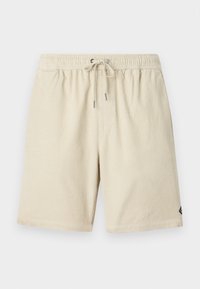 Beige corduroy shorts met een elastische tailleband en trekkoord, met een subtiele verticale ribbelstructuur en een klein label aan de zijkant.