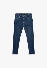 Siniset farkut, jotka ovat slim fit -tyyppiset, viidellä taskulla, napilla ja vetoketjulla varustettu sulkeminen sekä hillityt haalistumisdetaljit kankaassa.