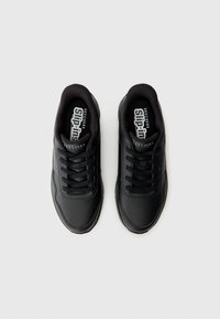 Baskets de sport noires avec une tige en cuir texturé, fermeture à lacets, détails perforés et semelle rembourrée. Logo sur la languette et sur le côté.