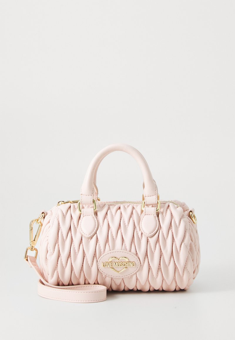 Pink faux leather handbag with quilted design, gold hardware, dual handles, and detachable strap. Featuring a gold logo plaque on the front.