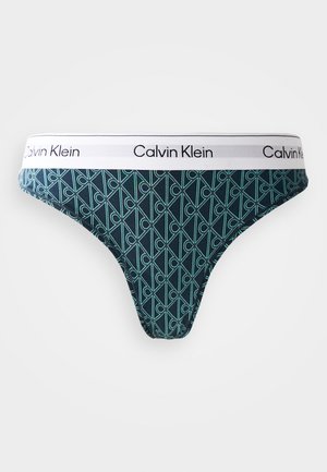 Temno modre tangice s teal geometrijskim vzorcem, z belim pasom z logotipom "Calvin Klein". Narejene so iz mehkega, raztegljivega materiala.