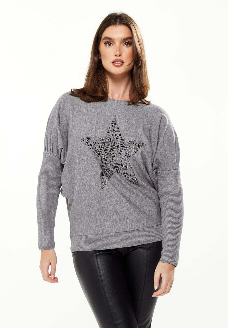 Gray knitted sweater with a loose fit, featuring a textured star design in black rhinestones on the front. Ribbed cuffs and hem.