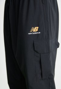 New Balance CLASSICS JOGGER - Tracksuit bottoms - black