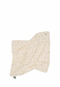 Ljus beige filt med ett subtilt mönster av små blommor, tillverkad av mjukt tyg. Har rundade kanter och ett grönt snöre i ett hörn.