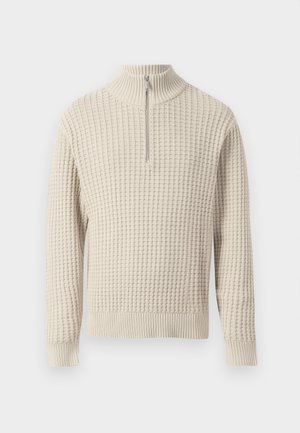 Beige ritsweater met hoge kraag, met een gestructureerd wafelstiksel en geribde manchetten en zoom. Gemaakt van zachte stof.