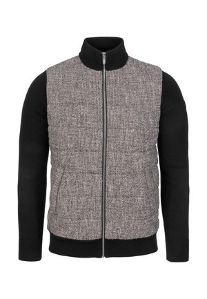 Prošívaná vesta se strukturovaným šedým předním dílem a černými pletenými rukávy. Má vysoký límec a zapínání vpředu na zip. Dvě boční kapsy.