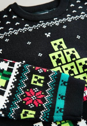 Sort striktrøje med klare grønne, hvide og multicolor geometriske mønstre. Ribbet krave og manchetter med pixelmønstre.