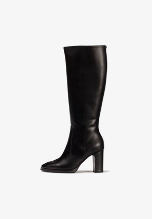 Botas de cuero negras hasta la rodilla con un diseño ajustado, puntera cuadrada y un tacón grueso. Textura suave con un detalle mínimo y un zipper lateral.