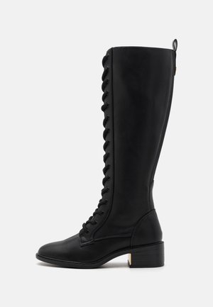 Tall black leather lace-up boot with block heel and back pull tab, shown in profile on light background.