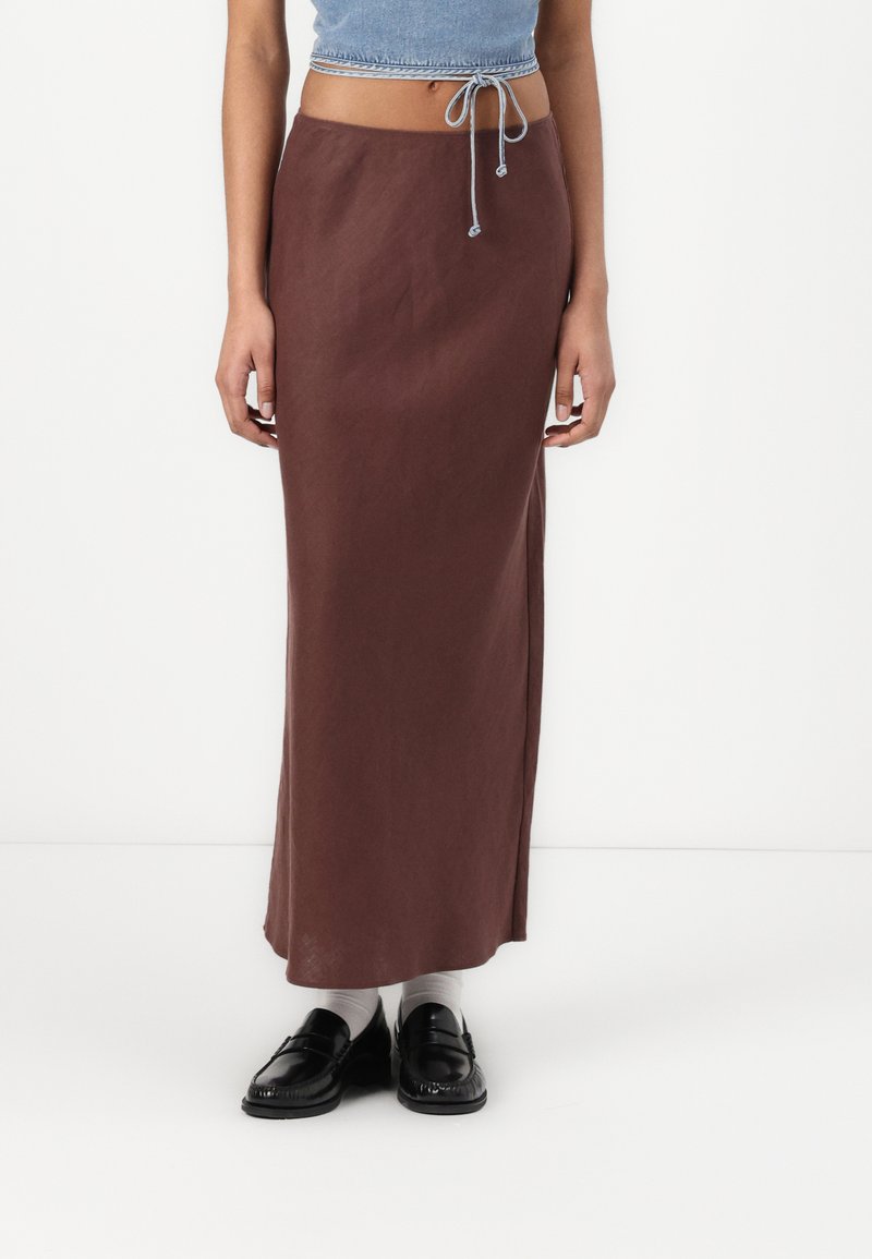 Brown, mid-length skirt made of soft fabric with a slightly shiny texture. Features a side slit and a drawstring waist for adjustment.