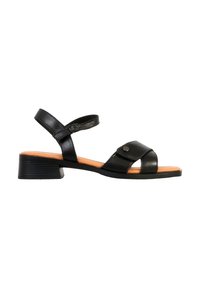 Sandale noire pour femme en cuir avec talon carré bas, bride de cheville avec boucle, et bride avant ornée de clous en métal.