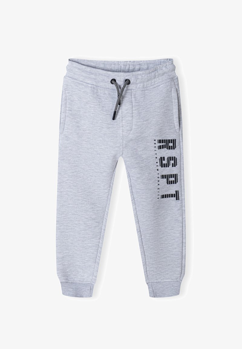 Light gray sweatpants made from a soft material, featuring an elastic waistband with a drawstring, side pockets, and black printed text on one leg.