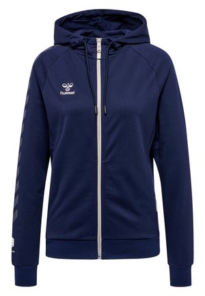 Mørkeblå zip-up hoodie lavet af blødt stof, med en hvid lynlås, justerbar hætte og skrå hvide linjer på ærmerne.