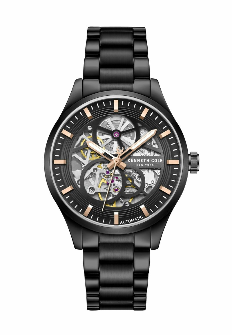 Orologio automatico nero con quadrante scheletrato, che mette in mostra meccanismi intricati, accentuato da elementi in oro e argento, e un bracciale in metallo nero.