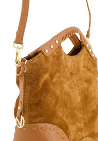 Sac à main en suède marron avec des accents en cuir tan, comportant des matériaux en or, des détails de couture et une bandoulière.