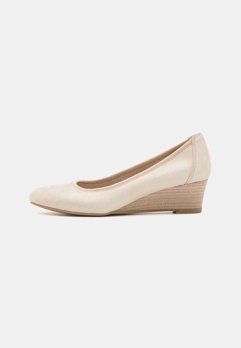 Beige suede wedge pump with a rounded toe, textured wedge heel, and smooth interior lining. Adjustable fit with subtle stitching details.